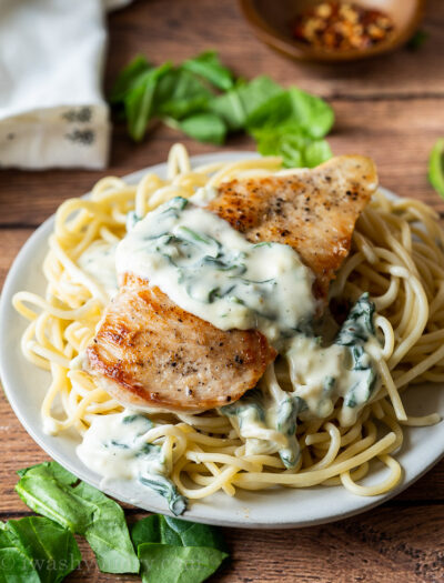 My family really LOVES this super easy chicken recipe! Creamy Garlic Parmesan Chicken with wilted spinach! YUM!