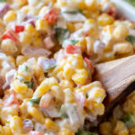 This Creamy Corn Salad Recipe is a quick and easy side dish that's filled with crisp corn kernels that pop in a creamy sauce; perfect for summer potlucks and bbq's!