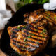 grilled pork chops on pan with parsley