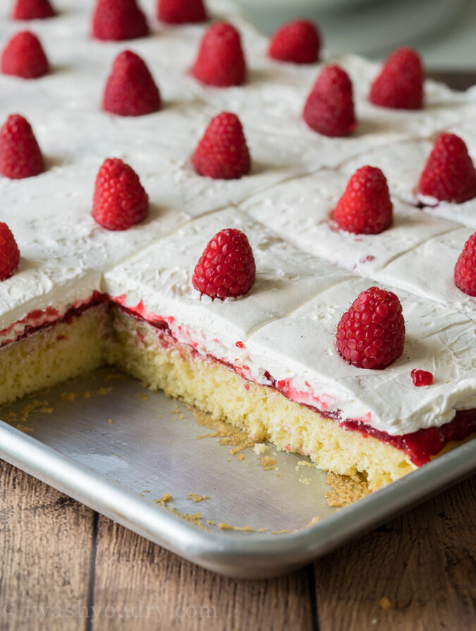 Moist and delicious Vanilla Cake recipe topped with raspberry cake filling and a fluffy cream cheese topping!