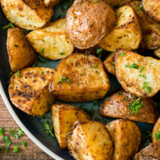 A tray of food, with roasted Potatoes