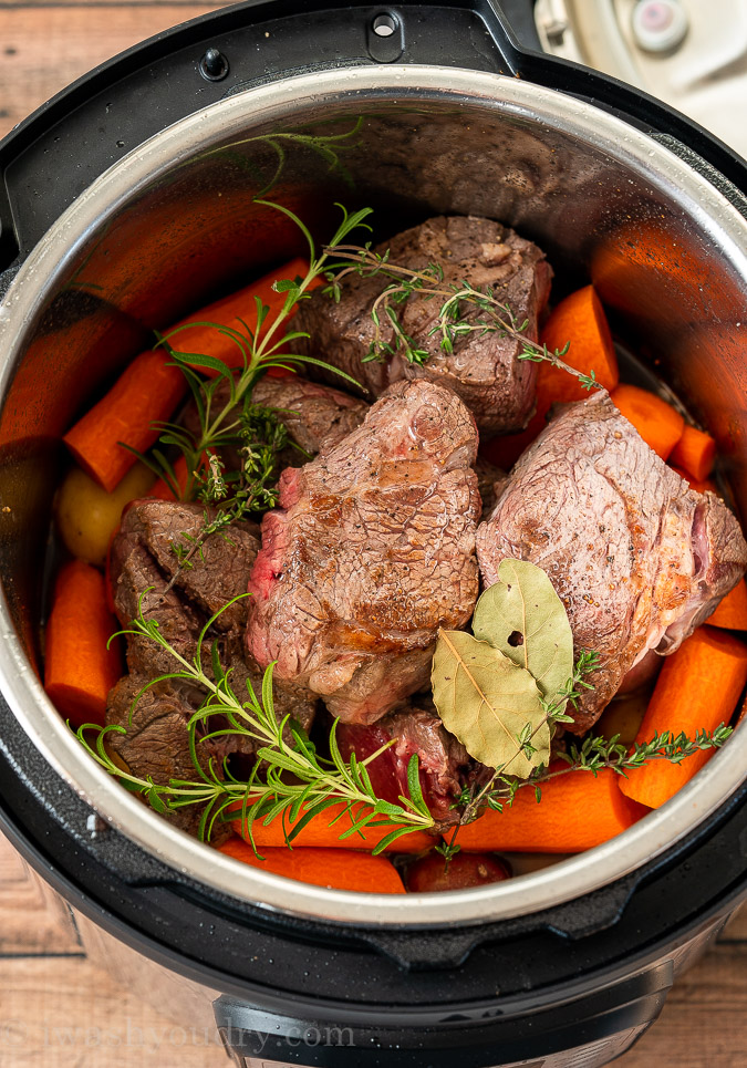 Instant Pot Pot Roast ingredients inside pot before being cooked.