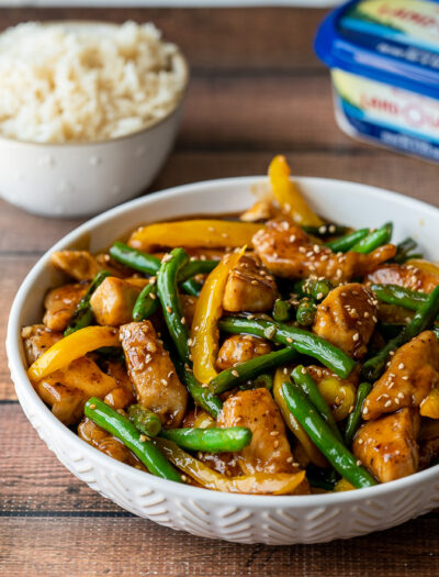 This quick and easy Honey Sesame Chicken Stir Fry is filled with tender chicken breast strips, green beans and yellow peppers in a sweet and sticky sauce.