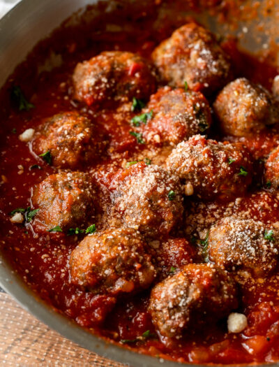 Easy Meatball Recipe in marinara sauce, topped with parmesan cheese