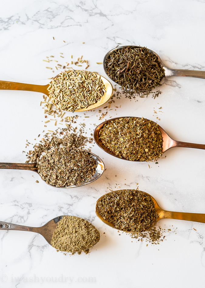 Dried herbs used to make Italian Seasoning in spoons on table