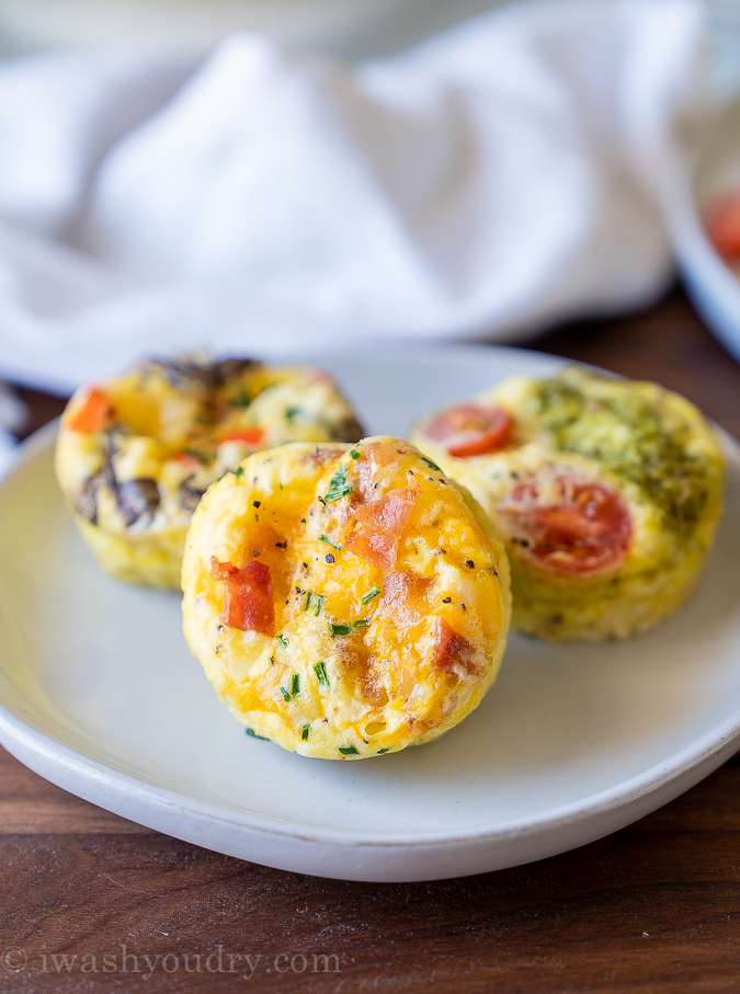 Three types of egg muffins on a white plate.