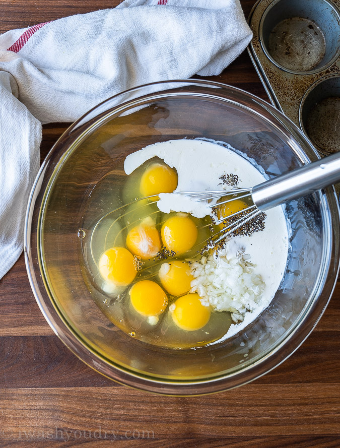 Frittata ingredients: Eggs, Heavy Cream, diced onion and salt and pepper in a large mixing bowl.