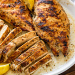 Juicy grilled chicken breast strips on a plate