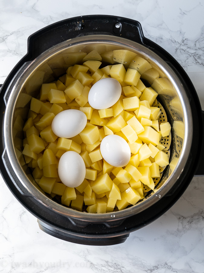 Instant Pot filled with diced potatoes and whole eggs