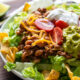 Close up of taco salad on white plate