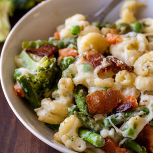 Big bowl full of veggie macaroni and cheese with bacon