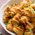 Crispy breaded chicken topped with bang bang sauce and green onions.