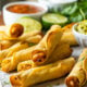 Plate full of crispy chicken taquitos