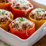 Casserole dish filled with cheesy stuffed peppers.