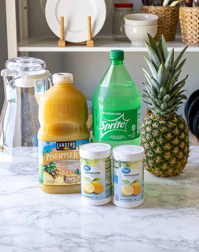 Pineapple Juice, Lemonade Concentrate and Sprite on a counter top