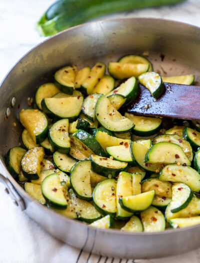 Sautéed Zucchini in a skillet with red pepper flakes.