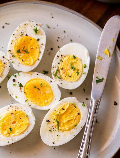 hard boiled eggs on plate with knife