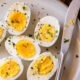 hard boiled eggs on plate with knife