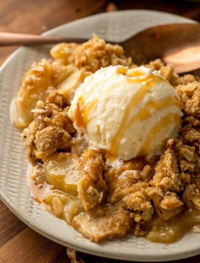 dessert on plate with apples and vanilla ice cream