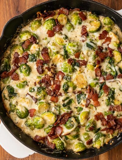 creamy brussels sprouts with bacon in a cast iron pan