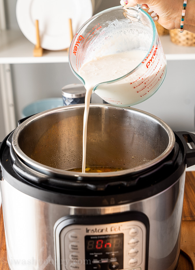 pouring cream mixture into soup