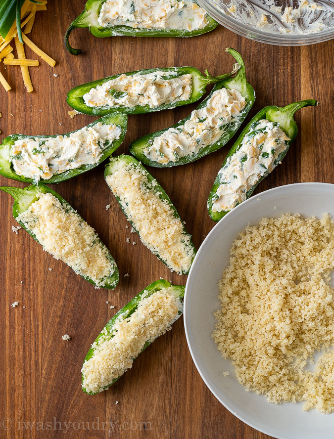 bowl of panko breadcrumbs with cream cheese stuffed jalapenos