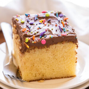 slice of vanilla cake with chocolate frosting