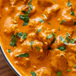 creamy chicken tikka masala in pan with cilantro