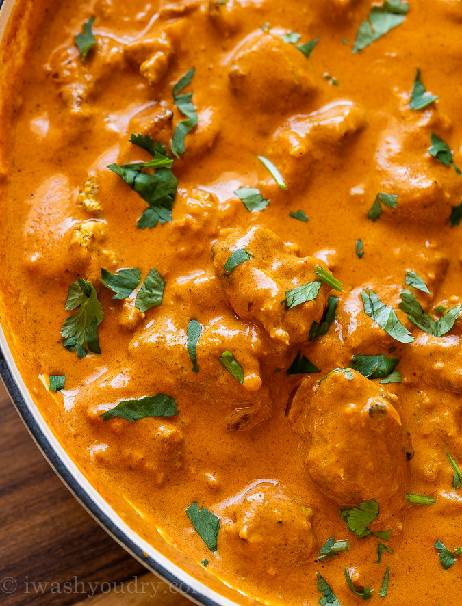 creamy chicken tikka masala in pan with cilantro