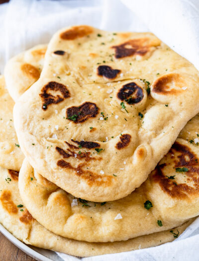 pile of soft naan bread on plate