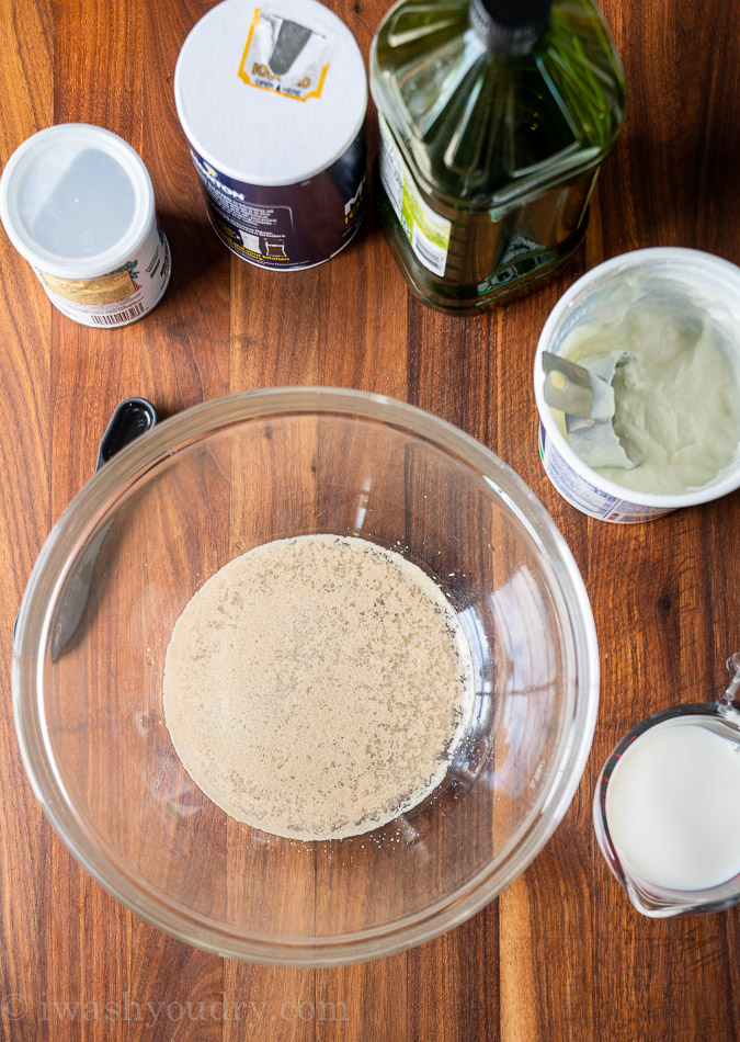 Ingredients needed to make naan bread on wood board