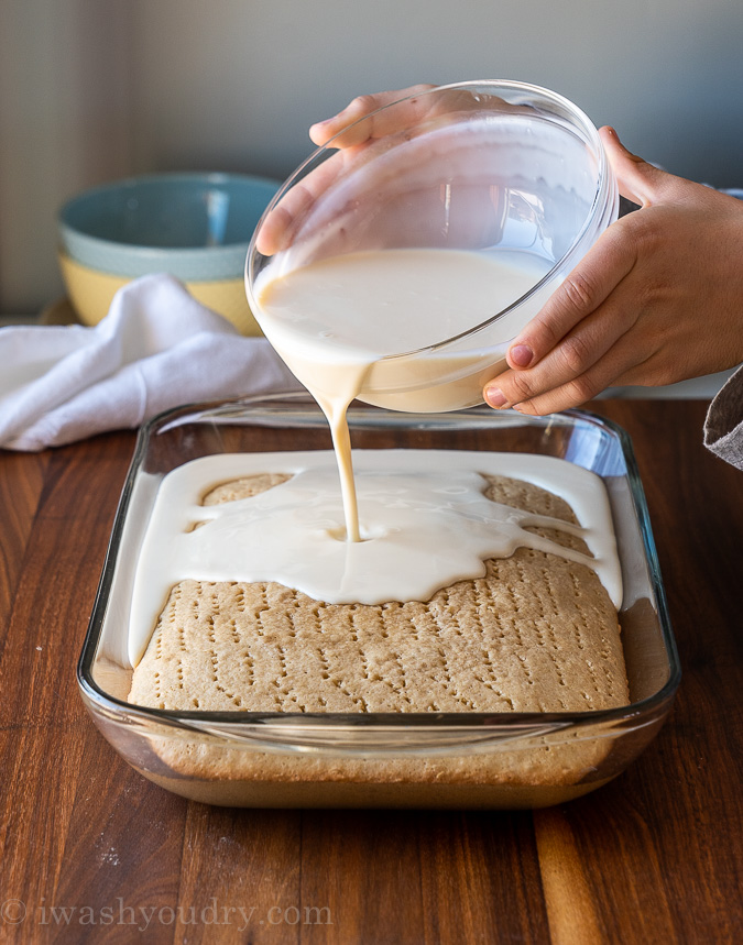 pouring three milks mixture over cake