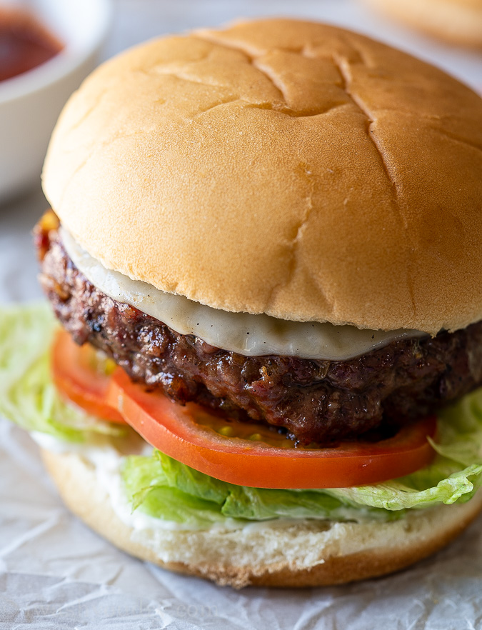 burger with cheese, tomato and lettuce