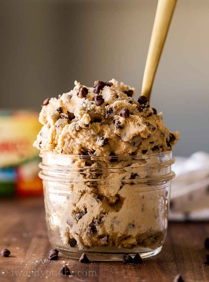 bowl filled with chocolate chip cookie dough and spoon