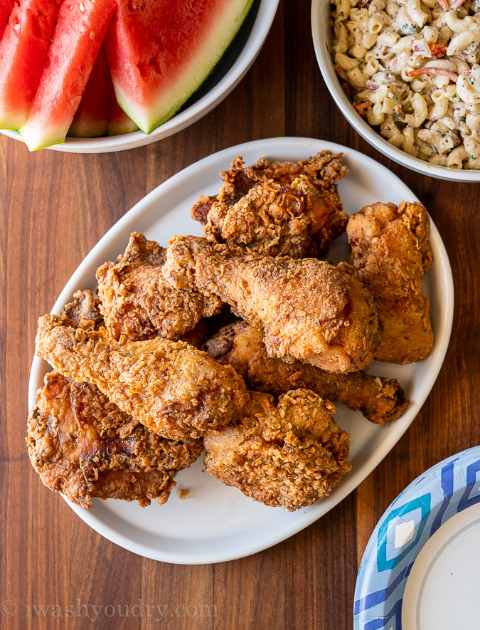 table spread with chicken, watermelon and macaroni salad