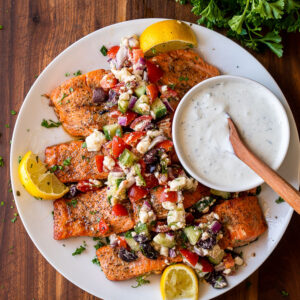 easy grilled salmon recipe with fresh greek salsa on top and side of tzatziki sauce