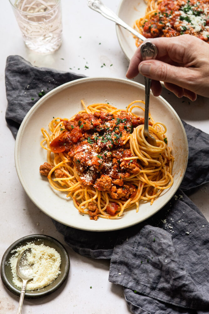 twirling pasta on fork with spaghetti sauce