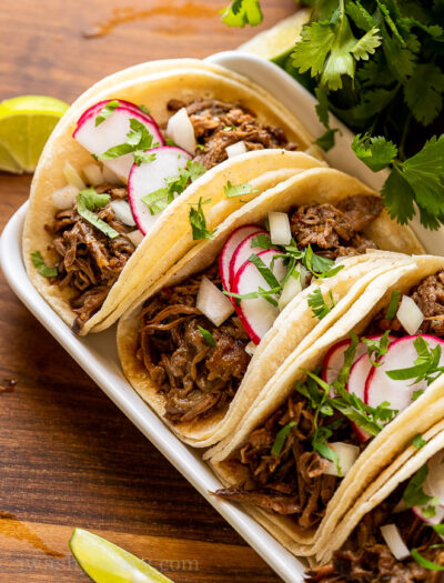 slow cooker barbacoa beef in taco shells with radish