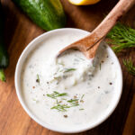 bowl of creamy greek tzatziki sauce with cucumbers and dill