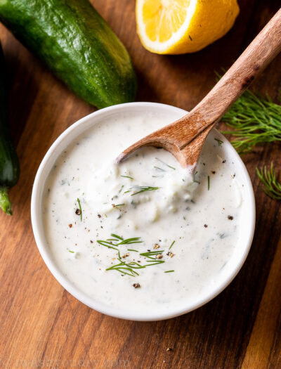 bowl of creamy greek tzatziki sauce with cucumbers and dill