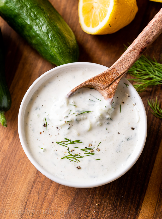 bowl of creamy greek tzatziki sauce with cucumbers and dill