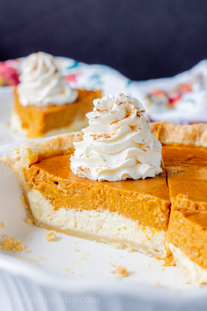 slice of cheesecake pumpkin pie in white pie pan. 