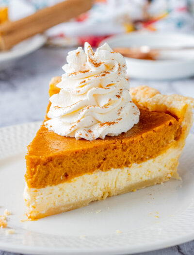 Slice of Pumpkin cheesecake pie on white plate.