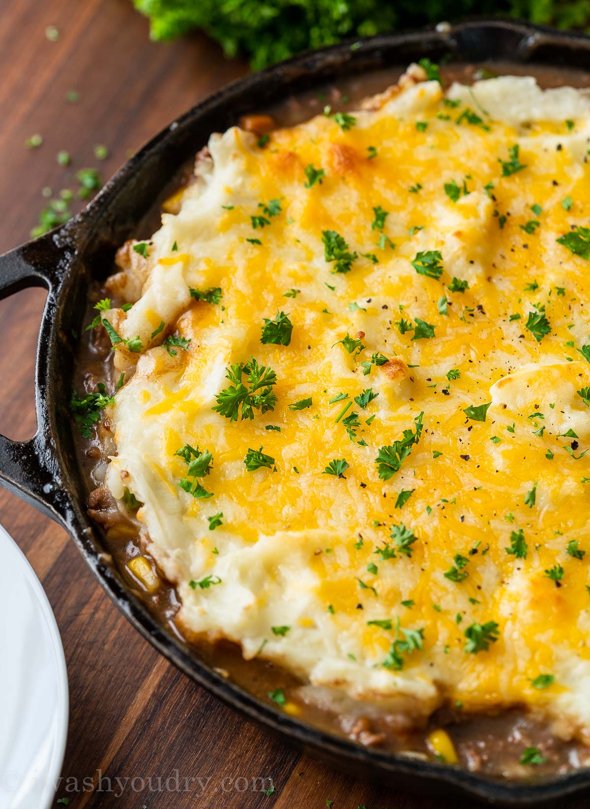 cast iron skillet with cottage pie and cheese