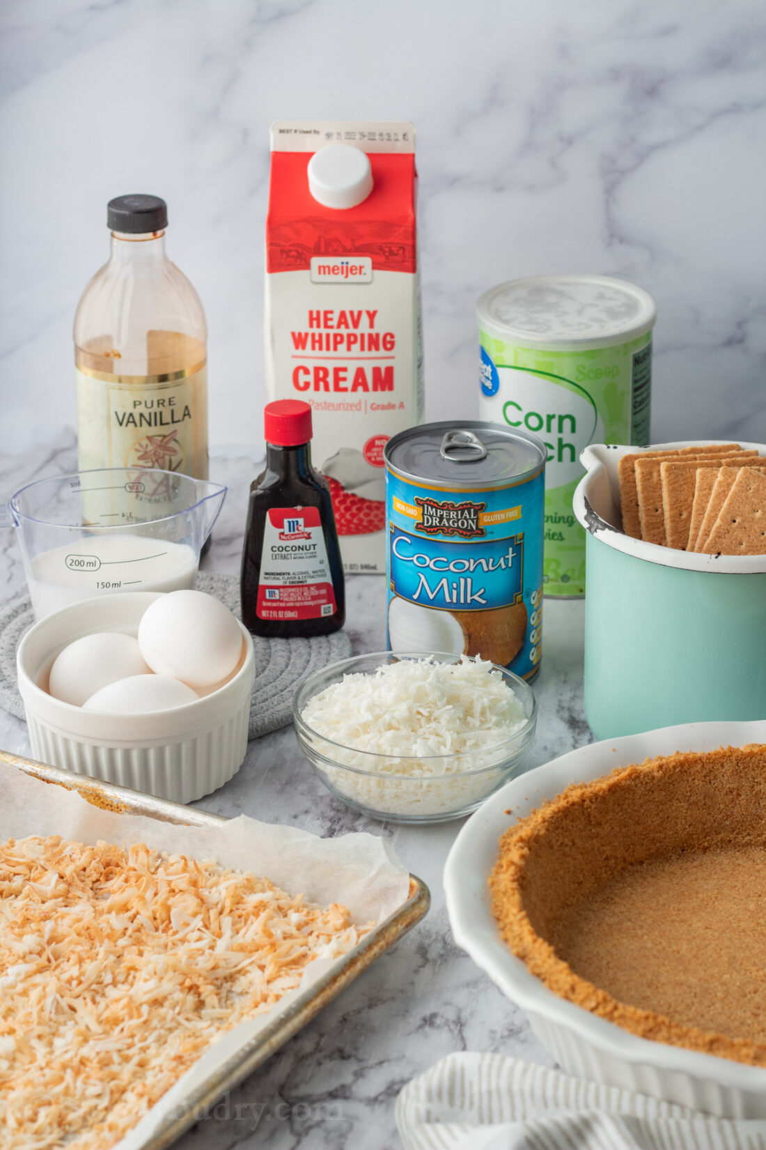 Ingredients for Coconut Cream Pie on marble countertop.