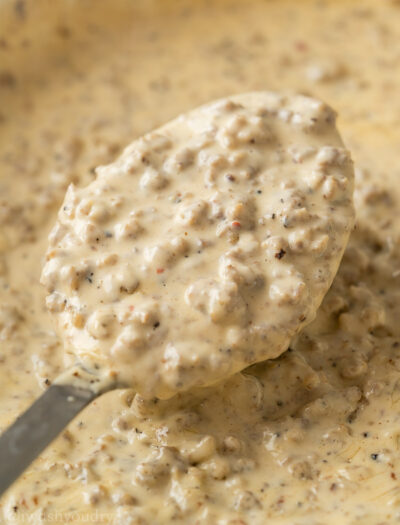 spoon filled with sausage gravy