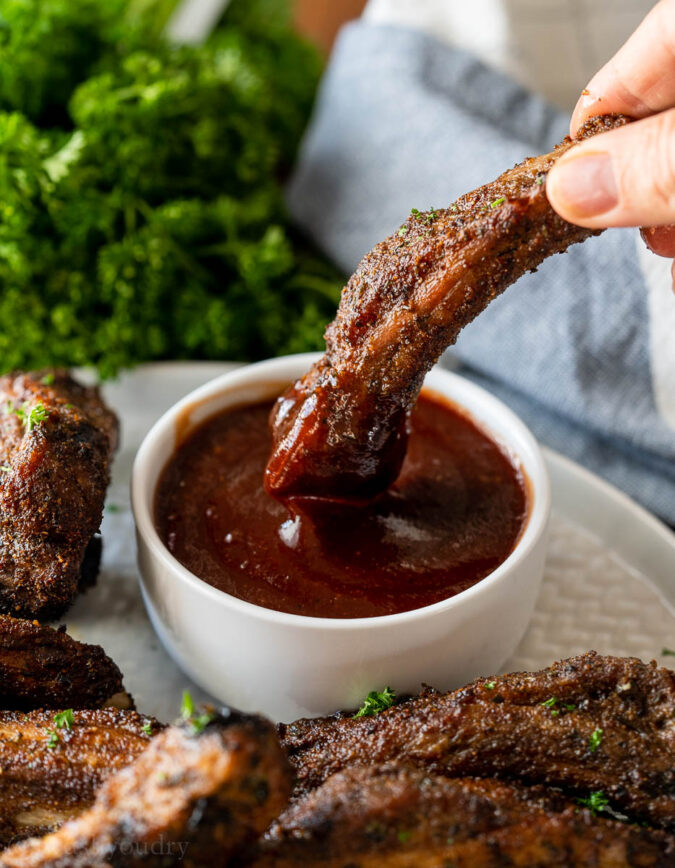 Dipping rib bone in bbq sauce