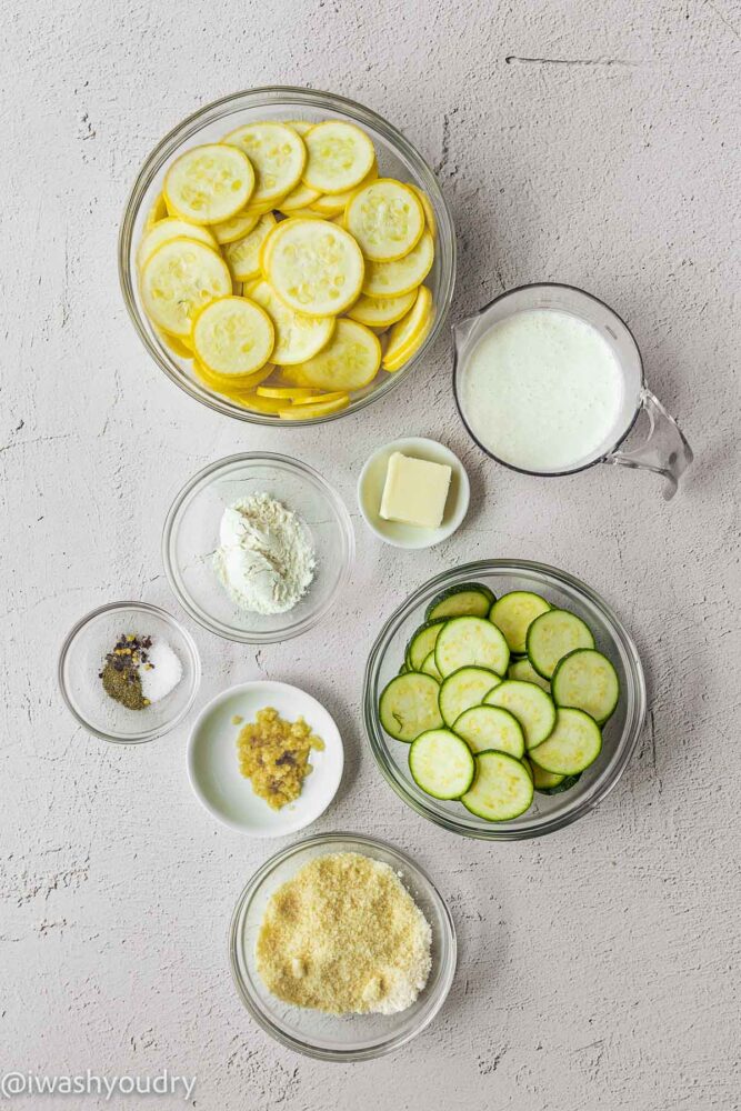 zucchini and squash with parmesan cheese on white surface