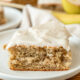 slice of banana cake with frosting on plate.