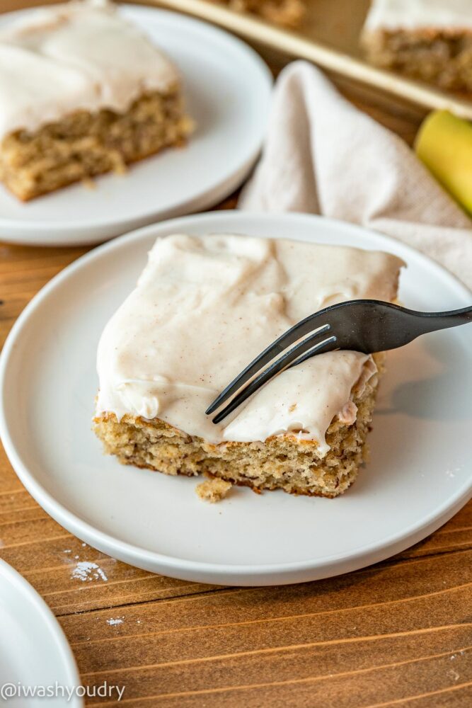 fork in banana cake on white plate.